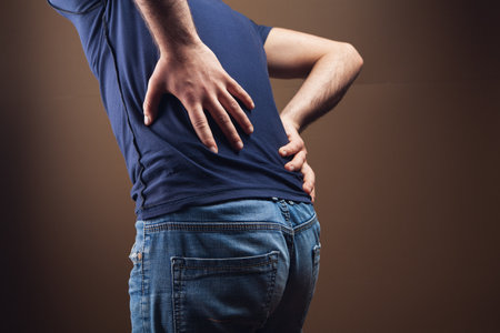 a man hurts kidneys on a brown background