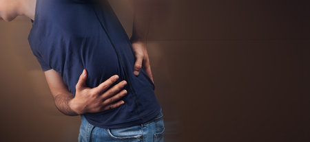 a man hurts kidneys on a brown background