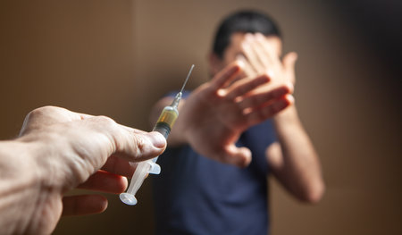 the man refuses to accept the syringe. vaccination concept. addictionの写真素材