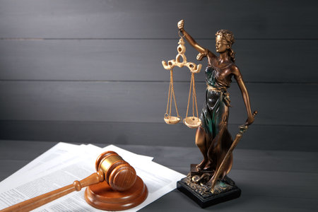 statue of justice, paper and gavel on a wooden table. court concept