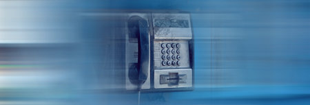 old telephone booth with blue background
