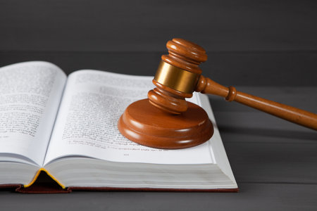 judge gavel and book on gray background