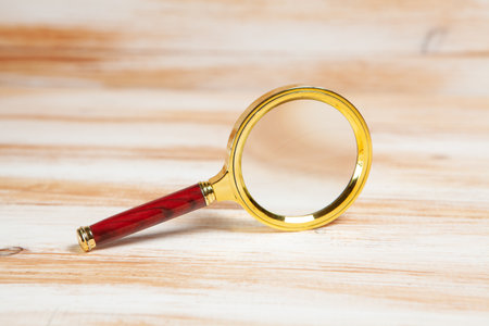 magnifying glass on a wooden tableの写真素材