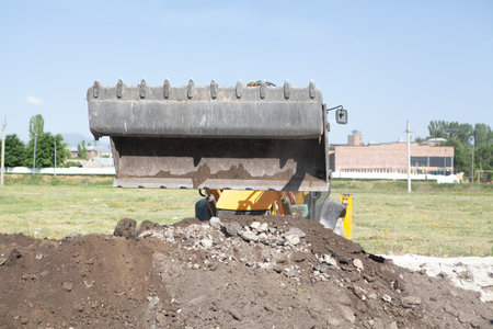 excavator and new building in the field. build a house