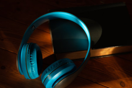 audiobook concept. book and headphones on a wooden table