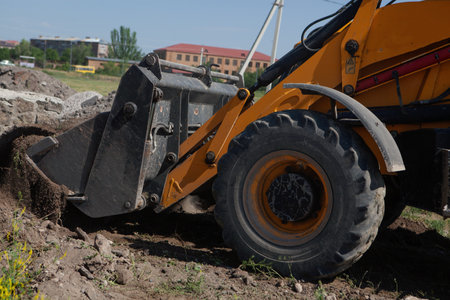 excavator and new building in the field. build a houseの写真素材