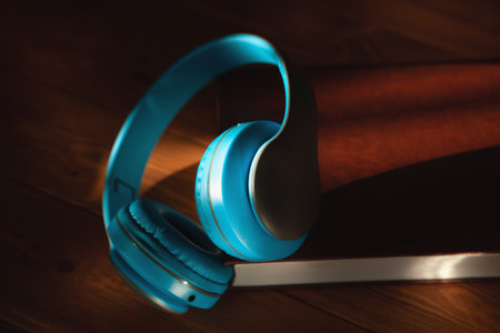 audiobook concept. book and headphones on a wooden tableの写真素材