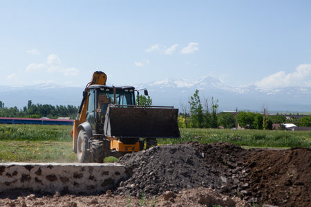 excavator and new building in the field. build a houseの写真素材