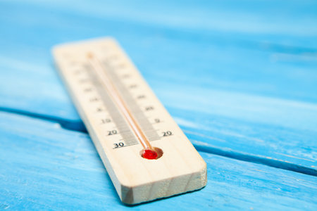 thermometer on blue wooden background