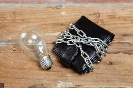 wallet in chains and a light bulb on the table