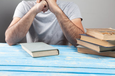 a man sitting in front of booksの写真素材