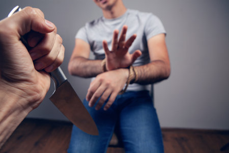 assault on a tied person with a knifeの写真素材