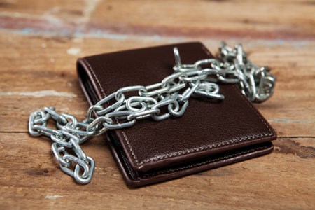 wallet in chains on the tableの写真素材