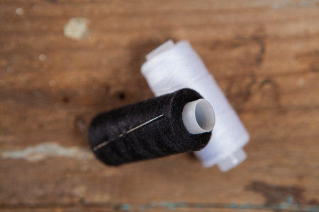 threads on the table. black and white threads on a wooden tableの写真素材