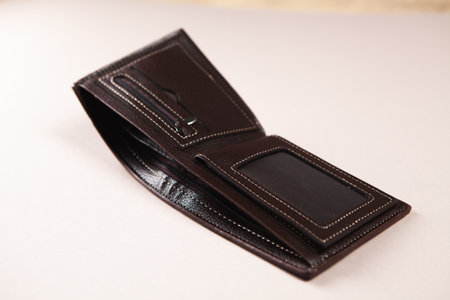 open empty leather wallet on the table