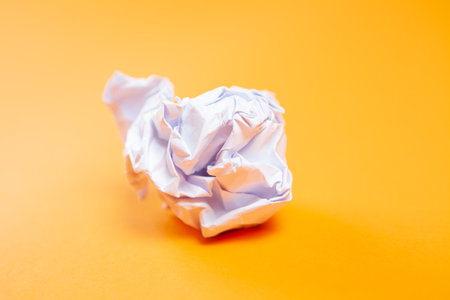 crumpled paper on orange backgroundの写真素材