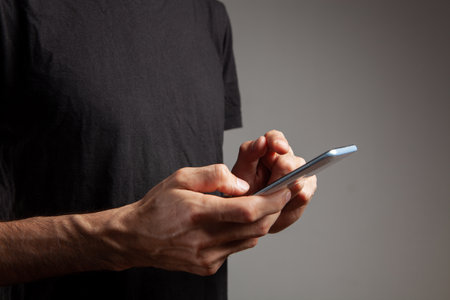 man presses on the phone screenの写真素材