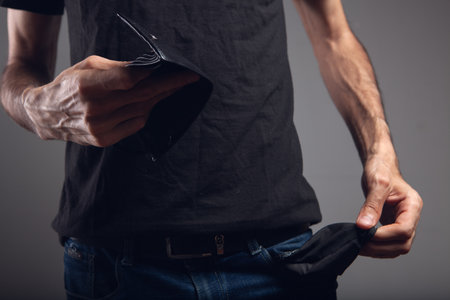 man showing empty pocket and empty walletの写真素材