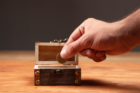 coin and old small chest on the tableの写真素材