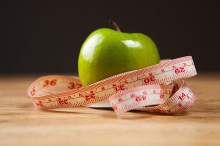 measuring tape and apples on the tableの写真素材