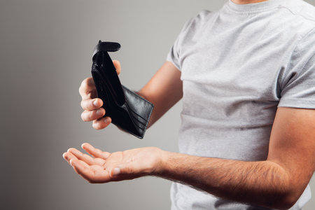 man shows an empty leather wallet.の写真素材