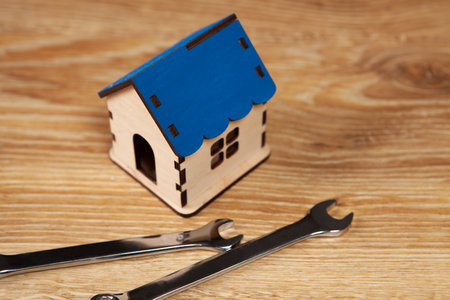 wrenches and house on the tableの写真素材