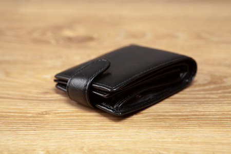 black wallet on a wooden tableの写真素材