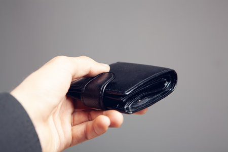hand holds a leather walletの写真素材