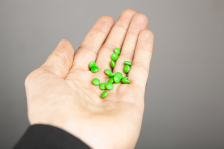 a man holding a pill in his hand