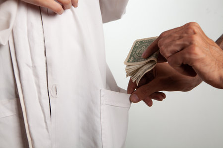 a man puts money in a doctor's pocket