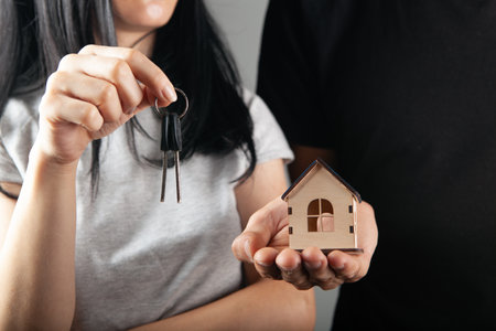 couple holding house and keysの写真素材