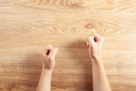 the woman hit the table with her fistの写真素材