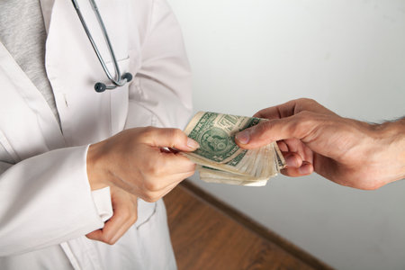 the doctor accepts money from a manの写真素材