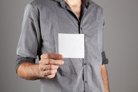man holding blank advertising paperの写真素材