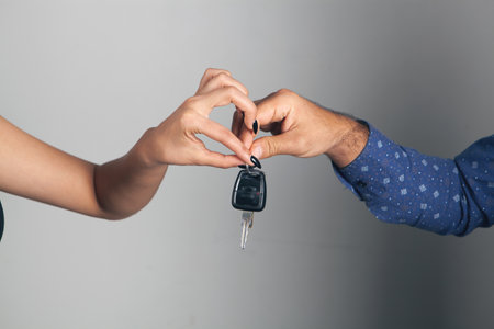 man gives car keys to womanの写真素材