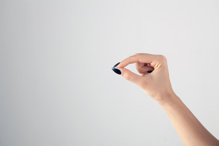 female hand showing clutch gestureの写真素材