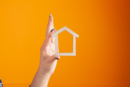 Young woman holding house in handsの写真素材