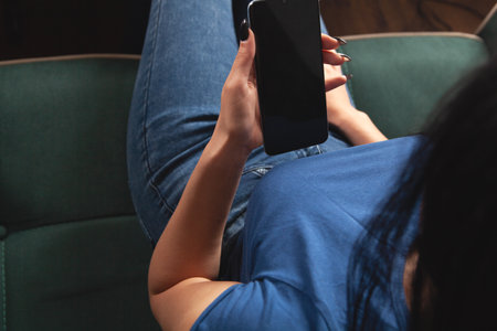 woman working on the phone while sittingの写真素材