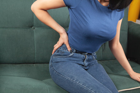 woman holding a kidney sitting on the couch