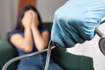 the doctor checks the woman's blood pressureの写真素材