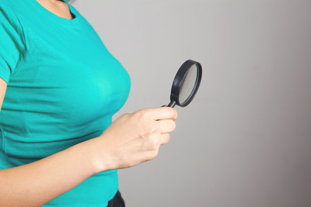 woman holding a magnifying glassの写真素材