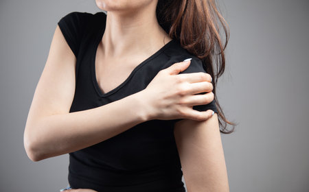 a young woman has a shoulder painの写真素材