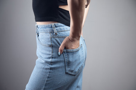 girl holding her hands in her back pocketsの写真素材