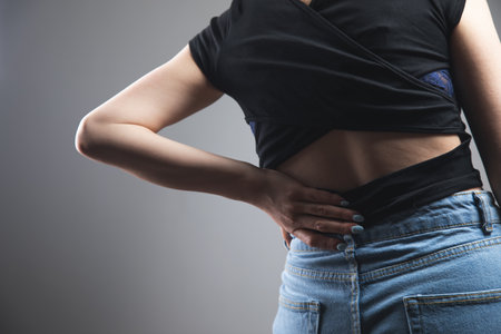 a young woman has a backacheの写真素材