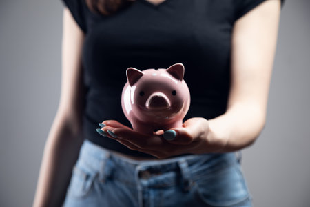 young woman holding a piggy bankの写真素材