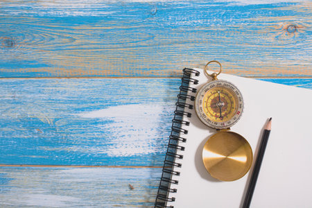 compass and pencil on notepad. travel notes concept
