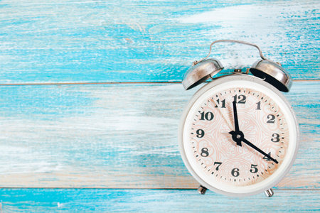 alarm clock on a blue wooden table