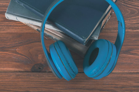 books and headphones on a wooden tableの写真素材