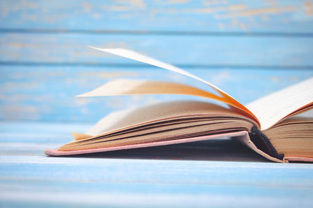 open book on blue wooden backgroundの写真素材