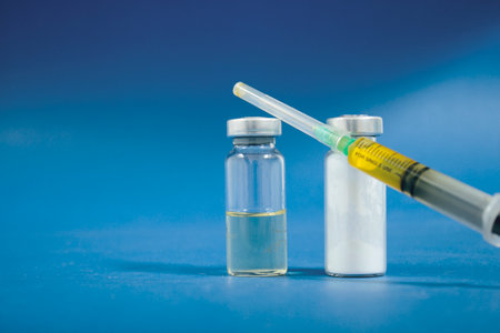 ampoules and syringe on a blue backgroundの写真素材